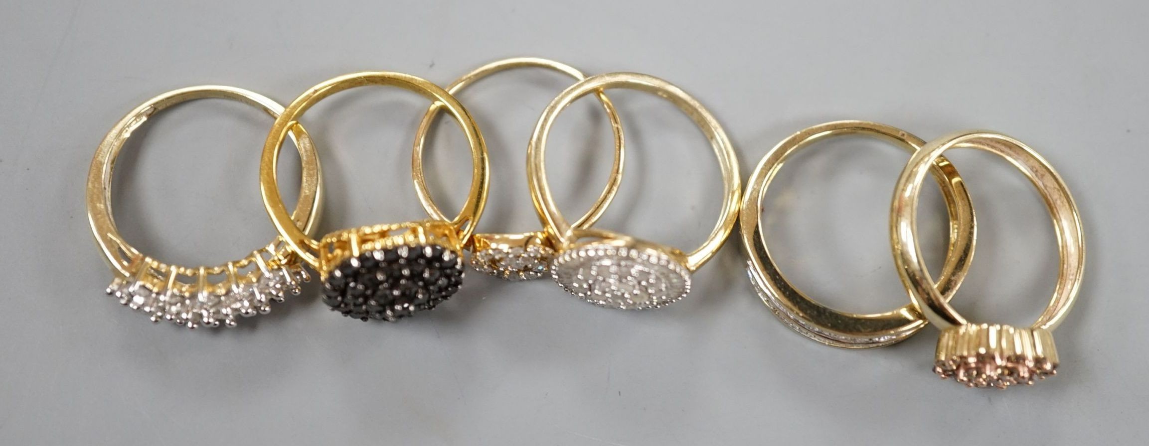 Four assorted modern 9ct gold and white or coloured diamond cluster set dress rings and two similar rings set in gilt 925